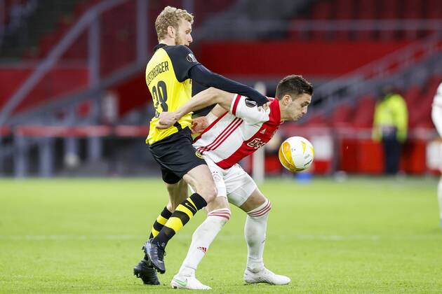 AMSTERDAM , 11-03-2021 , Johan Cruijff Arena , Dutch football , Europa League , round of sixteen first leg , season 2020 2021. (R-L)Ajax player Dusan Tadic and Young Boys player Fabian Lustenberger during the match Ajax vs Young Boys Ajax - Young Boys  x11072506x Copyright: