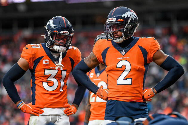 DENVER, CO - OCTOBER 31: Denver Broncos cornerback Pat Surtain II (2) and free safety Justin Simmons (31) look on as an injured player is tended to during a game between the Denver Broncos and the Washington Football Team at Empower Field at Mile High on October 31, 2021 in Denver, Colorado. (Photo by Dustin Bradford Icon Sportswire) NFL, American Football Herren, USA OCT 31 Washington Football Team at Broncos Icon132211031216