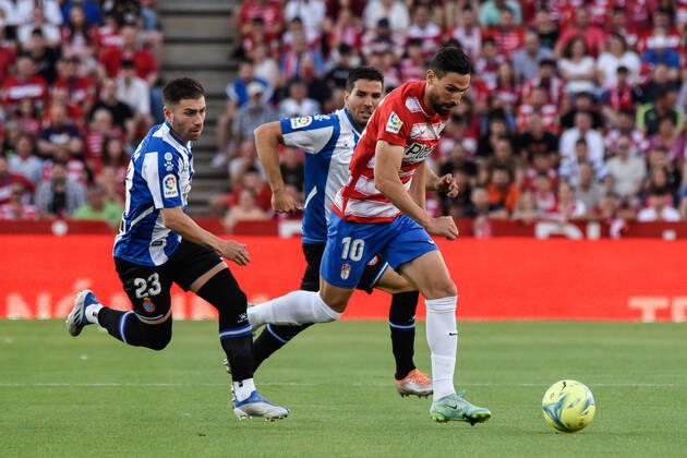 Spain: La Liga-Granada vs RCD Espanol Antonio Puertas of Granada CF being followed by Adrian Embarba of RCD Espanol and Leandro Cabrera of RCD Espanol during the Liga match between Granada CF and RCD Espanol at Nuevo Los Carmenes Stadium on May 10, 2022 in Granada, Spain. Granada Granada Spain Copyright: JosexMxBaldomero