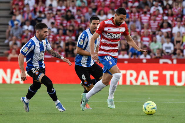 Spain: La Liga-Granada vs RCD Espanol Antonio Puertas of Granada CF being followed by Adrian Embarba of RCD Espanol and Leandro Cabrera of RCD Espanol during the Liga match between Granada CF and RCD Espanol at Nuevo Los Carmenes Stadium on May 10, 2022 in Granada, Spain. Granada Granada Spain Copyright: JosexMxBaldomero