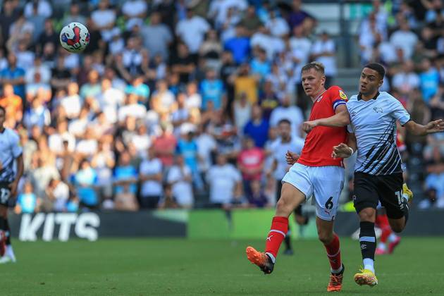 Derby County v Barnsley EFL Sky Bet League 1 13 08 2022. Mads Juel Anderson (6) of Barnsley kicks the ball under pressure from Lewis Dobbin (18) of Derby County during the EFL Sky Bet League 1 match between Derby County and Barnsley at the Pride Park, Derby, England on 13 August 2022. Editorial use only DataCo restrictions apply See www.football-dataco.com , Copyright: xJezxTighex PSI-15713-0072