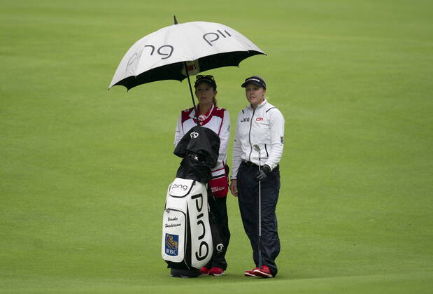 August 26, 2022, Ottawa, ON, Canada: Brooke Henderson and her caddy Brittany Henderson wait on the first fairway before play was suspended during the second day of action at the CP Womens Open, Friday, August 26, 2022 in Ottawa. Brooke Henderson Brittany Henderson  - ZUMAc35_ 20220826_zaf_c35_002 Copyright: xAdrianxWyldx