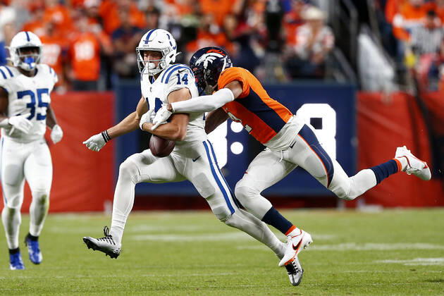 DENVER, CO - OCTOBER 06: Denver Broncos Cornerback Pat Surtain (2) strips the ball form Indianapolis Colts Wide Receiver Alec Pierce (14) during and NFL, American Football Herren, USA game between the Indianapolis Colts and the Denver Broncos on October 06, 2022 at Empower Field at Mile High in Denver CO. (Photo by Jeffrey Brown Icon Sportswire) NFL: OCT 06 Colts at Broncos Icon100622004