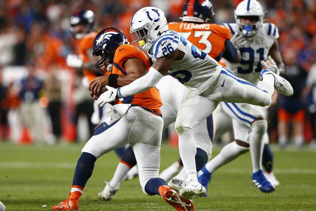 DENVER, CO - OCTOBER 06: Denver Broncos Quarterback Russell Wilson (3) ducks under the rushing Indianapolis Colts Safety Rodney McLeod (26) during and NFL, American Football Herren, USA game between the Indianapolis Colts and the Denver Broncos on October 06, 2022 at Empower Field at Mile High in Denver CO. (Photo by Jeffrey Brown Icon Sportswire) NFL: OCT 06 Colts at Broncos Icon100622012