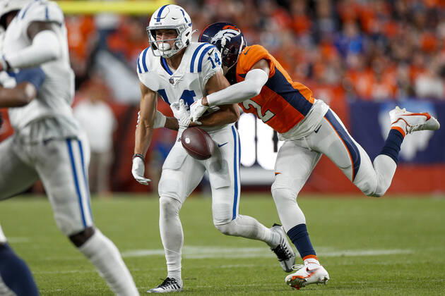 DENVER, CO - OCTOBER 06: Denver Broncos cornerback Pat Surtain II hits the ball causing a fumble by Indianapolis Colts wide receiver Alec Pierce (14) in the first half of an NFL, American Football Herren, USA game between the Indianapolis Colts and the Denver Broncos at Empower Field at Mile High on October 06, 2022 in Denver, Colorado. (Photo by Brandon Sloter Icon Sportswire) NFL: OCT 06 Colts at Broncos Icon221006138