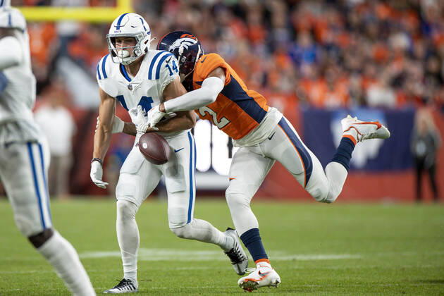 DENVER, CO - OCTOBER 06: Denver Broncos cornerback Pat Surtain II hits the ball causing a fumble by Indianapolis Colts wide receiver Alec Pierce (14) in the first half of an NFL, American Football Herren, USA game between the Indianapolis Colts and the Denver Broncos at Empower Field at Mile High on October 06, 2022 in Denver, Colorado. (Photo by Brandon Sloter Icon Sportswire) NFL: OCT 06 Colts at Broncos Icon221006139