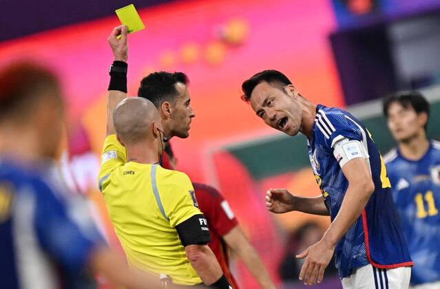 Russia Soccer World Cup Japan - Spain 8329413 01.12.2022 Referee Maya Yoshida shows a yellow card to Japan s during the Qatar 2022 World Cup Group E soccer match between Japan and Spain, in Doha, Qatar. Grigory Sysoev Sputnik Doha Qatar  Copyright: xGrigoryxSysoevx