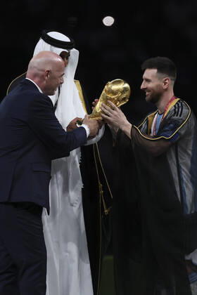 (221218) -- LUSAIL, Dec. 18, 2022 -- FIFA President Gianni Infantino (L) awards Lionel Messi (R) of Argentina during the awarding ceremony of the 2022 FIFA World Cup, WM, Weltmeisterschaft, Fussball at Lusail Stadium in Lusail, Qatar, Dec. 18, 2022. ) (SP)QATAR-LUSAIL-2022 WORLD CUP-FINAL-ARG VS FRA LanxHongguang