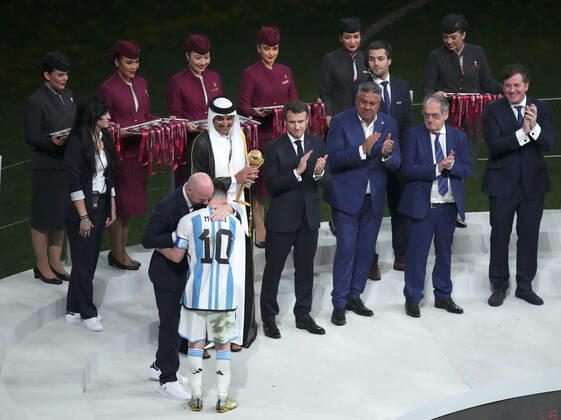 (221218) -- LUSAIL, Dec. 18, 2022 -- FIFA President Gianni Infantino hugs Lionel Messi (front) of Argentina during the awarding ceremony of the 2022 FIFA World Cup, WM, Weltmeisterschaft, Fussball at Lusail Stadium in Lusail, Qatar, Dec. 18, 2022. ) (SP)QATAR-LUSAIL-2022 WORLD CUP-FINAL-ARG VS FRA PanxYulong