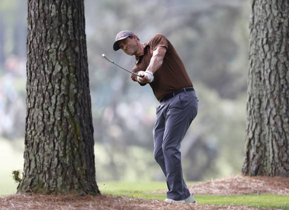 Adam Scott hits from the pine straw in the trees during the first round at the Masters tournament at Augusta National Golf Club in Augusta, Georgia on Thursday, April 6, 2023.  AUG20230406216 JOHNxANGELILLO