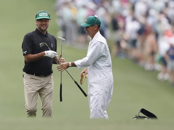 Bubba Watson receives his putter from caddie Brandon Parsons after approach shot on the first hole during the first round at the Masters tournament at Augusta National Golf Club in Augusta, Georgia on Thursday, April 6, 2023.  AUG20230406253 JOHNxANGELILLO