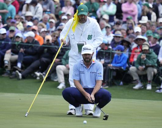 Cameron Young lines up a putt with the help of caddie Paul Tesoro on the 2nd hole during the final round at the 87th Masters tournament at Augusta National Golf Club in Augusta, Georgia on Sunday, April 9, 2023.  AUG20230409202 BOBxSTRONG