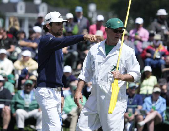 Joaquin Niemann looks over putt with caddie Gary Matthews on the 2nd hole during the final round at the 87th Masters tournament at Augusta National Golf Club in Augusta, Georgia on Sunday, April 9, 2023.  AUG20230409203 BOBxSTRONG