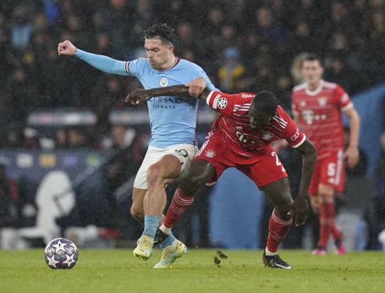Manchester, England, 11th April 2023. Jack Grealish of Manchester City pressure Dayot Upamecano of Bayern Munich during the UEFA Champions League match at the Etihad Stadium, Manchester. Picture credit should read: Andrew Yates Sportimage EDITORIAL USE ONLY. No use with unauthorised audio, video, data, fixture lists, club league logos or live services. Online in-match use limited to 120 images, no video emulation. No use in betting, games or single club league player publications. SPI-2360-0069