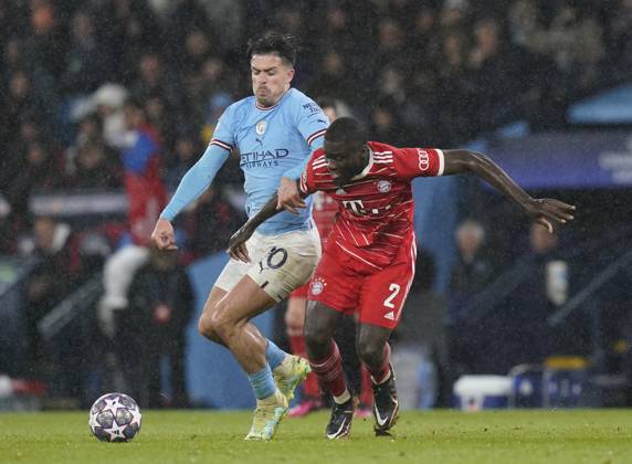 Manchester, England, 11th April 2023. Jack Grealish of Manchester City pressure Dayot Upamecano of Bayern Munich during the UEFA Champions League match at the Etihad Stadium, Manchester. Picture credit should read: Andrew Yates Sportimage EDITORIAL USE ONLY. No use with unauthorised audio, video, data, fixture lists, club league logos or live services. Online in-match use limited to 120 images, no video emulation. No use in betting, games or single club league player publications. SPI-2360-0070