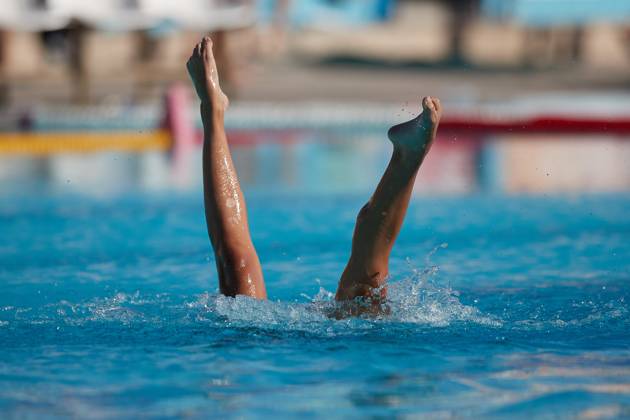 TAL-QROQQ, MALTA, 29 APRIL 2023: The legs of Malta national team, Nationalteam artistic swimmer Ana Culic (mostly submerged), point upwards out of the water during her artistic swimming performance at the National Pool, Tal-Qroqq, Malta on 29 April 2023. Ana Culic - Malta Artistic Swimmer AQUA_MAS_2023