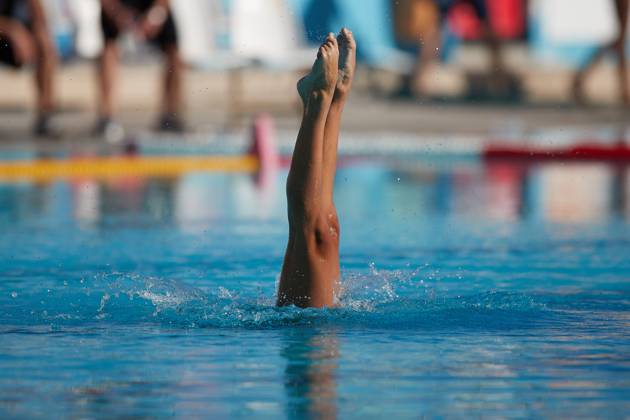 TAL-QROQQ, MALTA, 29 APRIL 2023: The legs of Malta national team, Nationalteam artistic swimmer Ana Culic (mostly submerged), point up out of the water during her artistic swimming performance at the National Pool, Tal-Qroqq, Malta on 29 April 2023. Ana Culic - Malta Artistic Swimmer AQUA_MAS_2023