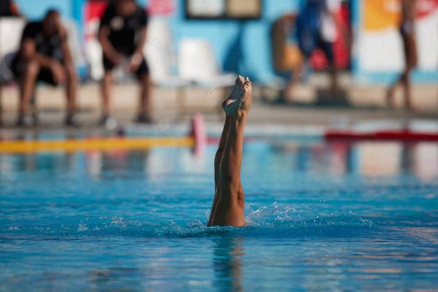 TAL-QROQQ, MALTA, 29 APRIL 2023: The legs of Malta national team, Nationalteam artistic swimmer Ana Culic (mostly submerged), point up out of the water during her artistic swimming performance at the National Pool, Tal-Qroqq, Malta on 29 April 2023. Ana Culic - Malta Artistic Swimmer AQUA_MAS_2023