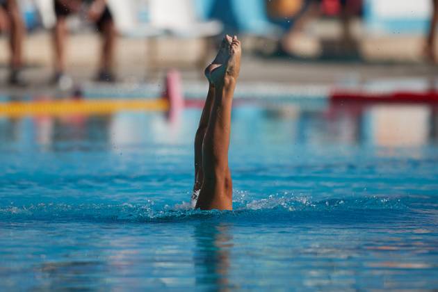 TAL-QROQQ, MALTA, 29 APRIL 2023: The legs of Malta national team, Nationalteam artistic swimmer Ana Culic (mostly submerged), point up out of the water during her artistic swimming performance at the National Pool, Tal-Qroqq, Malta on 29 April 2023. Ana Culic - Malta Artistic Swimmer AQUA_MAS_2023