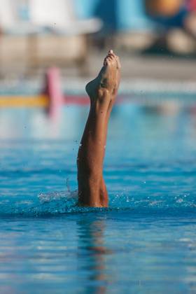 TAL-QROQQ, MALTA, 29 APRIL 2023: The legs of Malta national team, Nationalteam artistic swimmer Ana Culic (mostly submerged), point up out of the water during her artistic swimming performance at the National Pool, Tal-Qroqq, Malta on 29 April 2023. Ana Culic - Malta Artistic Swimmer AQUA_MAS_2023