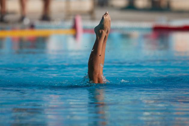 TAL-QROQQ, MALTA, 29 APRIL 2023: The legs of Malta national team, Nationalteam artistic swimmer Ana Culic (mostly submerged), point up out of the water during her artistic swimming performance at the National Pool, Tal-Qroqq, Malta on 29 April 2023. Ana Culic - Malta Artistic Swimmer AQUA_MAS_2023