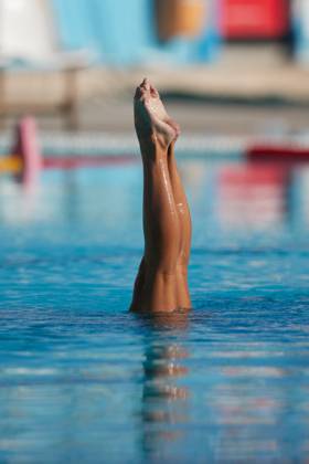 TAL-QROQQ, MALTA, 29 APRIL 2023: The legs of Malta national team, Nationalteam artistic swimmer Ana Culic (mostly submerged), point up out of the water during her artistic swimming performance at the National Pool, Tal-Qroqq, Malta on 29 April 2023. Ana Culic - Malta Artistic Swimmer AQUA_MAS_2023