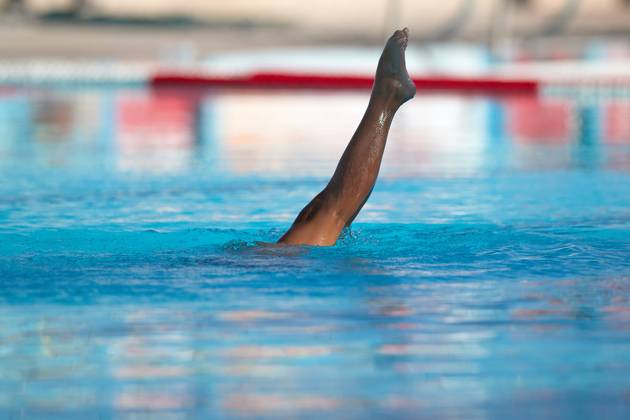 TAL-QROQQ, MALTA, 29 APRIL 2023: The legs of Malta national team, Nationalteam artistic swimmer Ana Culic (mostly submerged), point up out of the water during her artistic swimming performance at the National Pool, Tal-Qroqq, Malta on 29 April 2023. Ana Culic - Malta Artistic Swimmer AQUA_MAS_2023