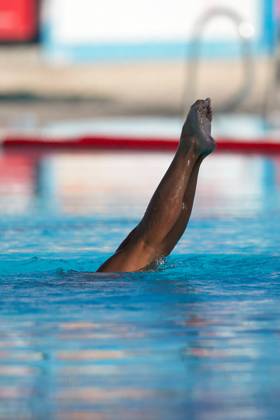TAL-QROQQ, MALTA, 29 APRIL 2023: The legs of Malta national team, Nationalteam artistic swimmer Ana Culic (mostly submerged), point up out of the water during her artistic swimming performance at the National Pool, Tal-Qroqq, Malta on 29 April 2023. Ana Culic - Malta Artistic Swimmer AQUA_MAS_2023