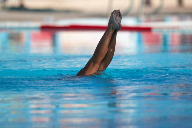 TAL-QROQQ, MALTA, 29 APRIL 2023: The legs of Malta national team, Nationalteam artistic swimmer Ana Culic (mostly submerged), point up out of the water during her artistic swimming performance at the National Pool, Tal-Qroqq, Malta on 29 April 2023. Ana Culic - Malta Artistic Swimmer AQUA_MAS_2023