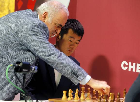 (230507) -- BUCHAREST, May 7, 2023 -- Former World Chess Champion, Garry Kasparov (L) of Russia, makes the first symbolic move for the round 1 match between Ding Liren of China and Maxime Vachier-Lagrave of France at Grand Chess Tour 2023 in downtown Bucharest, capital of Romania, May 6, 2023. (Photos by Xinhua) (SP)ROMANIA-BUCHAREST-CHESS-GRAND TOUR CristianxCristel