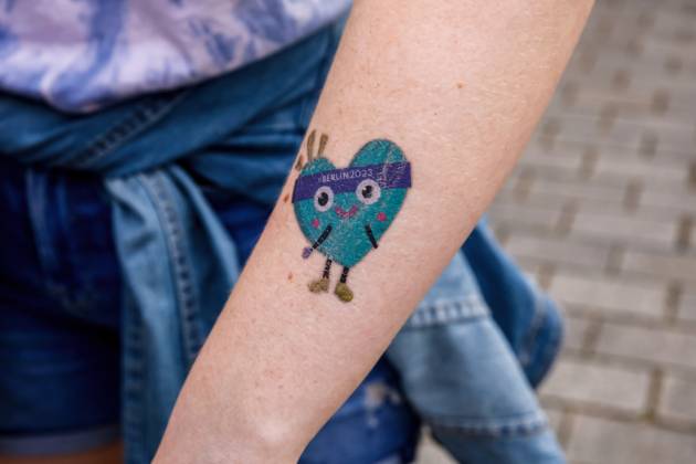 June 22, 2023, Berlin, Germany: A participant shows a tattoo with the mascot Unity during the street party for athletes and supporters of the Special Olympics. Summer World Games Berlin 2023 in front of the Brandenburg Gate in the center of Berlin. The 2023 Berlin Games hosts 7000 athletes with learning disabilities from nearly 190 countries. Special Olympics is an international charity which aims to include individuals with learning disabilities into the realm of Olympic sports. Berlin 2023 is the biggest sporting and charitable event of 2023. Berlin Germany - ZUMAs197 20230622_zaa_s197_574 Copyright: xDominikaxZarzyckax