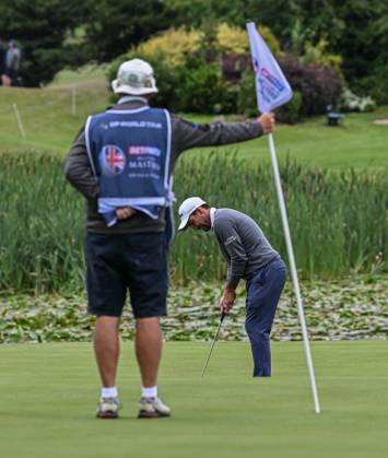 2nd July 2023; The Belfry, Sutton Coldfield, West Midlands, England: Betfred British Masters Golf, Day 4; Edoardo Molinari s caddy holds the flag while he putts  ActionPlus12526237 GodfreyxPitt