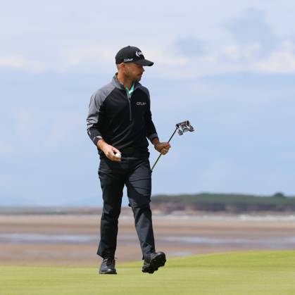 American Brian Harman walks on the thirteenth green on the second day at the 151st Open Championship at Royal Liverpool Golf Club in Hoylake, England on Friday, July 21, 2023. Harman is currently leading the Open on ten under par.  LON2023072118 HUGOxPHILPOTT