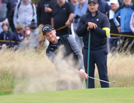 England s Danny Willett hits out of the bunker on the eighth green on the second day at the 151st Open Championship at Royal Liverpool Golf Club in Hoylake, England on Friday, July 21, 2023. Harman is currently leading the Open on ten under par.  LON2023072101111 HUGOxPHILPOTT
