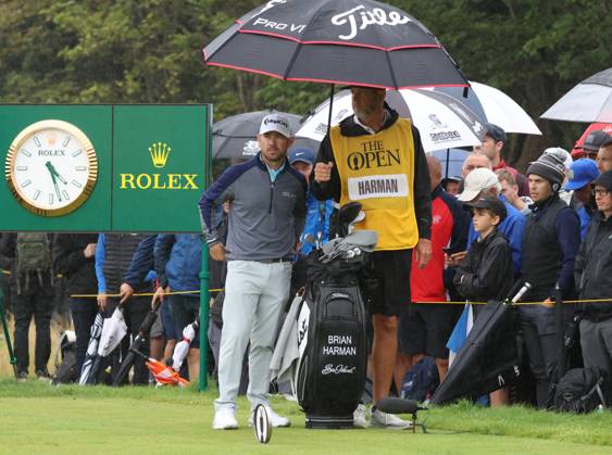 American Brian Harman shelters under an umbrella on the fifth tee on the third day at the 151st Open Championship at Royal Liverpool Golf Club in Hoylake, England on Saturday, July 22, 2023.  LON2023072231 HUGOxPHILPOTT