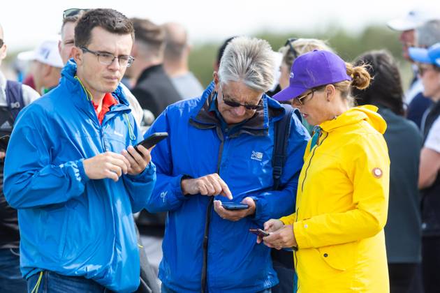 29th July 2023; Royal Porthcawl, Porthcawl, Bridgend, Wales: Senior Open Championship, Round 3; Spectators check their apps on their phones for the tee off list.  ActionPlus12536830 DanxMinto