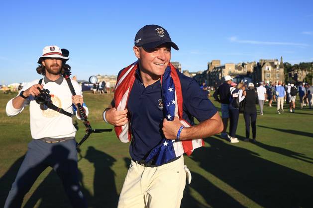 3rd September 2023; Old Course at St Andrews, St Andrews, Fife, Scotland; Walker Cup, Final Round; Austin Greaser of the United States of America celebrates with an American flag after securing the point which retained the Walker Cup for the USA  ActionPlus12550604 DavidxYoung