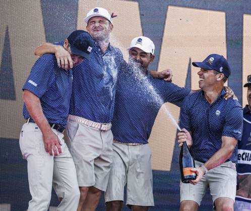 Paul Casey of England (R) sprays his teammages Charles Howell III of the US (L) Bryson DeChambeau of the US (2 L) and Anirban Lahiri of India (2R) after they won the team competition of the 2023 LIV Golf League tournament at Rich Harvest Farms in Sugar Grove, Illinois, on Sunday, September 24, 2023. Tournament play runs from September 22nd through the 24th.  SGI20230924835 TANNENxMAURY
