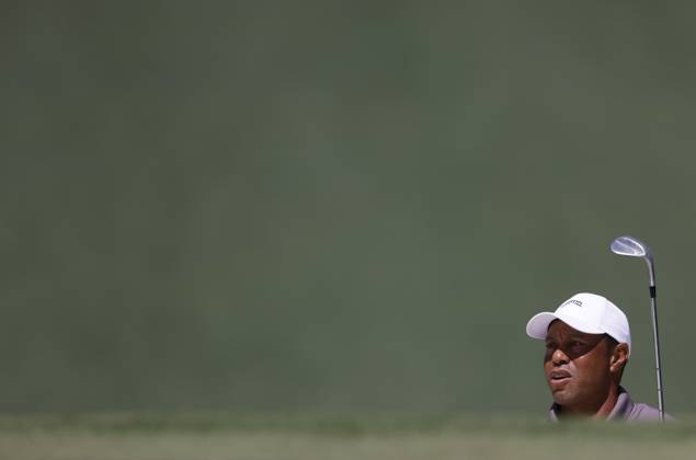 Tiger Woods watches his shot out of a bunker on the seventh green in the second round of the Masters Tournament at Augusta National Golf Club in Augusta, Georgia on Friday, April 12, 2024.  AUG20240412526 TANNENxMAURY