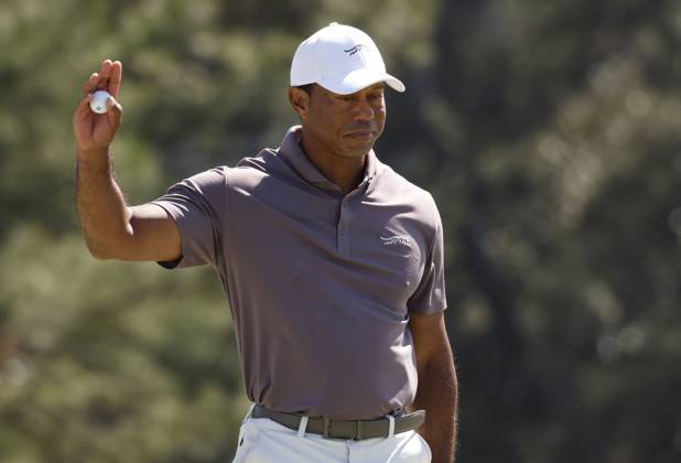 Tiger Woods waves after sinking a putt on the eighteenth green during the second round of the Masters Tournament at Augusta National Golf Club in Augusta, Georgia on Friday, April 12, 2024. Woods finished the day at one-over-par.  AUG20240412131 JOHNxANGELILLO