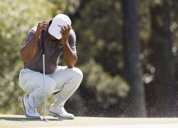 Sport Bilder des Tages Tiger Woods covers his face as gusting wind blows sand from the bunker across the eighteenth green during the second round of the Masters Tournament at Augusta National Golf Club in Augusta, Georgia on Friday, April 12, 2024. Woods finished the day at one-over-par.  AUG202404121006 JOHNxANGELILLO