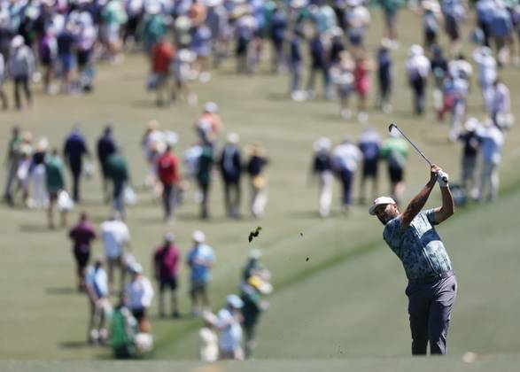 John Rahm of Spain hits his approach shot on the first hole during the second round of the Masters Tournament at Augusta National Golf Club in Augusta, Georgia on Friday, April 12, 2024.  AUG202404121003 JOHNxANGELILLO