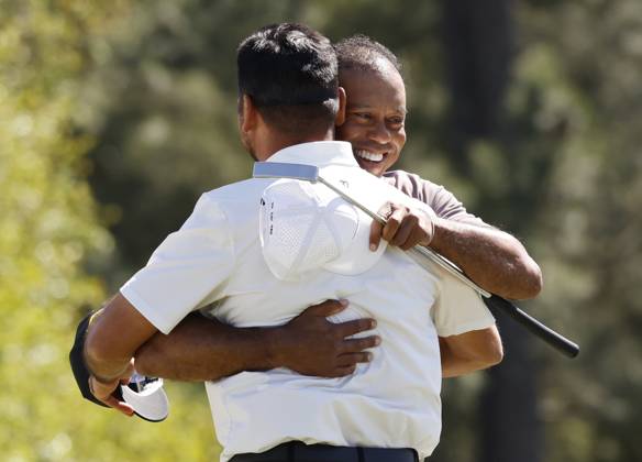 Tiger Woods hugs Jason Day on the eighteenth green in the second round of the Masters Tournament at Augusta National Golf Club in Augusta, Georgia on Friday, April 12, 2024. Tiger Woods set a Masters record with his 24th straight made cut at Augusta National.  AUG202404121009 JOHNxANGELILLO