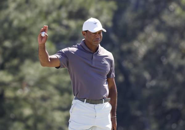 Tiger Woods hugs Jason Day on the eighteenth green in the second round of the Masters Tournament at Augusta National Golf Club in Augusta, Georgia on Friday, April 12, 2024. Tiger Woods set a Masters record with his 24th straight made cut at Augusta National.  AUG20240412144 JOHNxANGELILLO