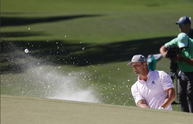 Bryson DeChambeau hits out of a bunker on the seventh hole during the third round of the Masters Tournament at Augusta National Golf Club in Augusta, Georgia on Saturday, April 13, 2024.  AUG20240413537 TANNENxMAURY