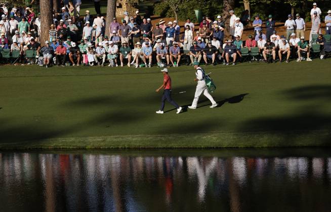 Collin Morikawa and his caddie walk to the sixteenth green during the third round of the Masters Tournament at Augusta National Golf Club in Augusta, Georgia on Saturday, April 13, 2024.  AUG20240413149 JOHNxANGELILLO