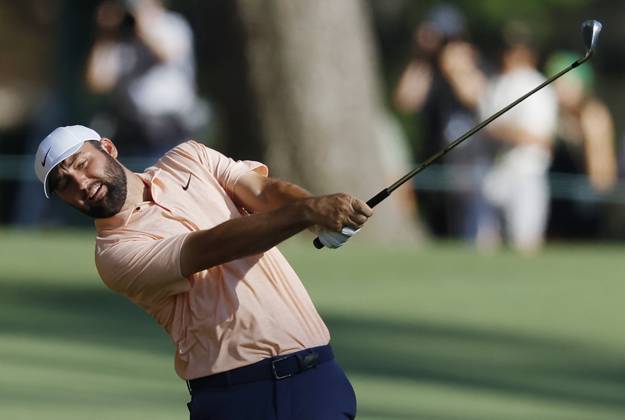 Scottie Scheffler hits an approach shot on the fifteenth hole on the final day of the Masters Tournament at Augusta National Golf Club in Augusta, Georgia on Sunday, April 14, 2024.  AUG20240414138 JOHNxANGELILLO