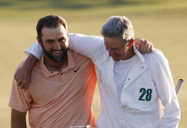 Scottie Scheffler celebrates with caddie Ted Scott after winning the Masters tournament at Augusta National Golf Club in Augusta, Georgia on Sunday, April 14, 2024. Scheffler won with a score of 11 under par.  AUG20240414546 TANNENxMAURY