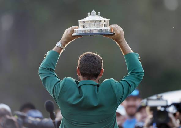 Scottie Scheffler raises his trophy after winning the Masters tournament at Augusta National Golf Club in Augusta, Georgia on Sunday, April 14, 2024. Scheffler won with a score of 11 under par.  AUG20240414173 JOHNxANGELILLO