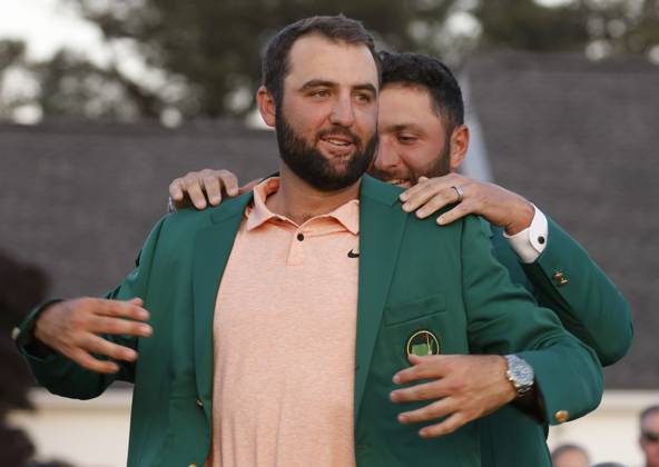 Masters winner Scottie Scheffler receives his Green Jacket from last years winner Jon Rahm after the final round of the Masters tournament at Augusta National Golf Club in Augusta, Georgia on Sunday, April 14, 2024. Scheffler won with a score of 11 under par.  AUG20240414577 TANNENxMAURY